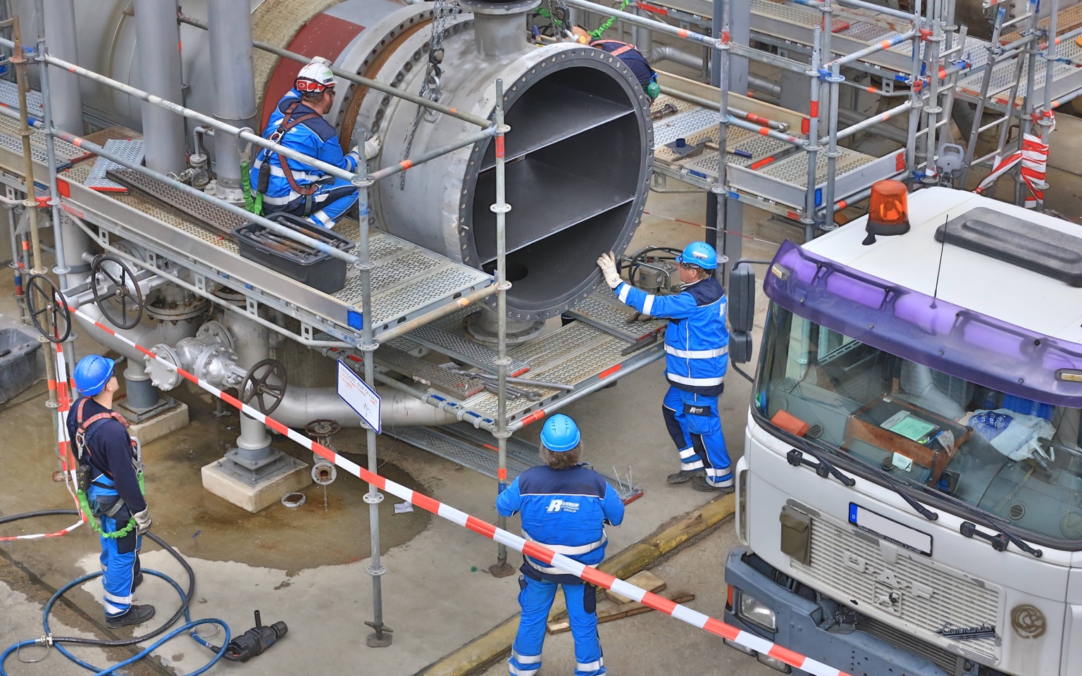 Maintenance crew working on industrial plant equipment